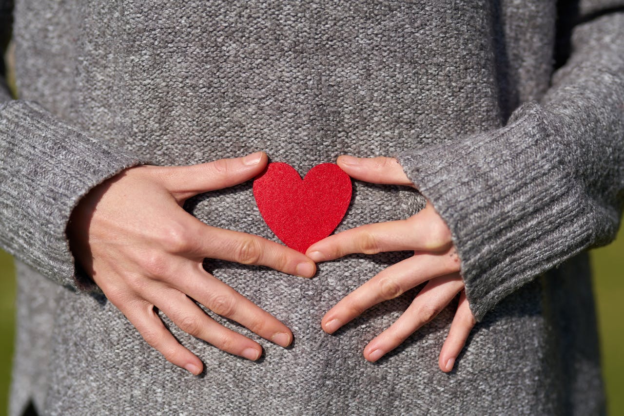 Patient holding red heart symbol representing digestive health